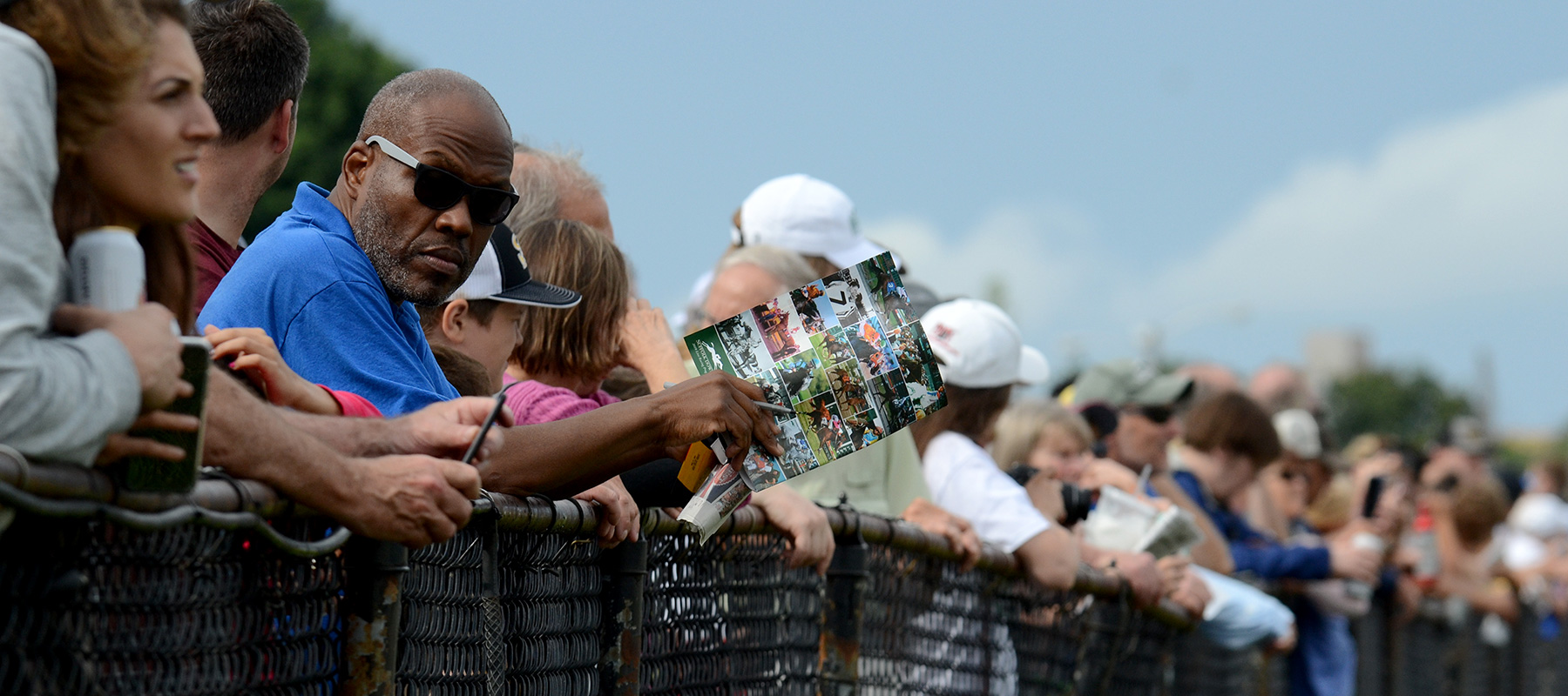 The crowd along the grandstand rail at Suffolk Downs
